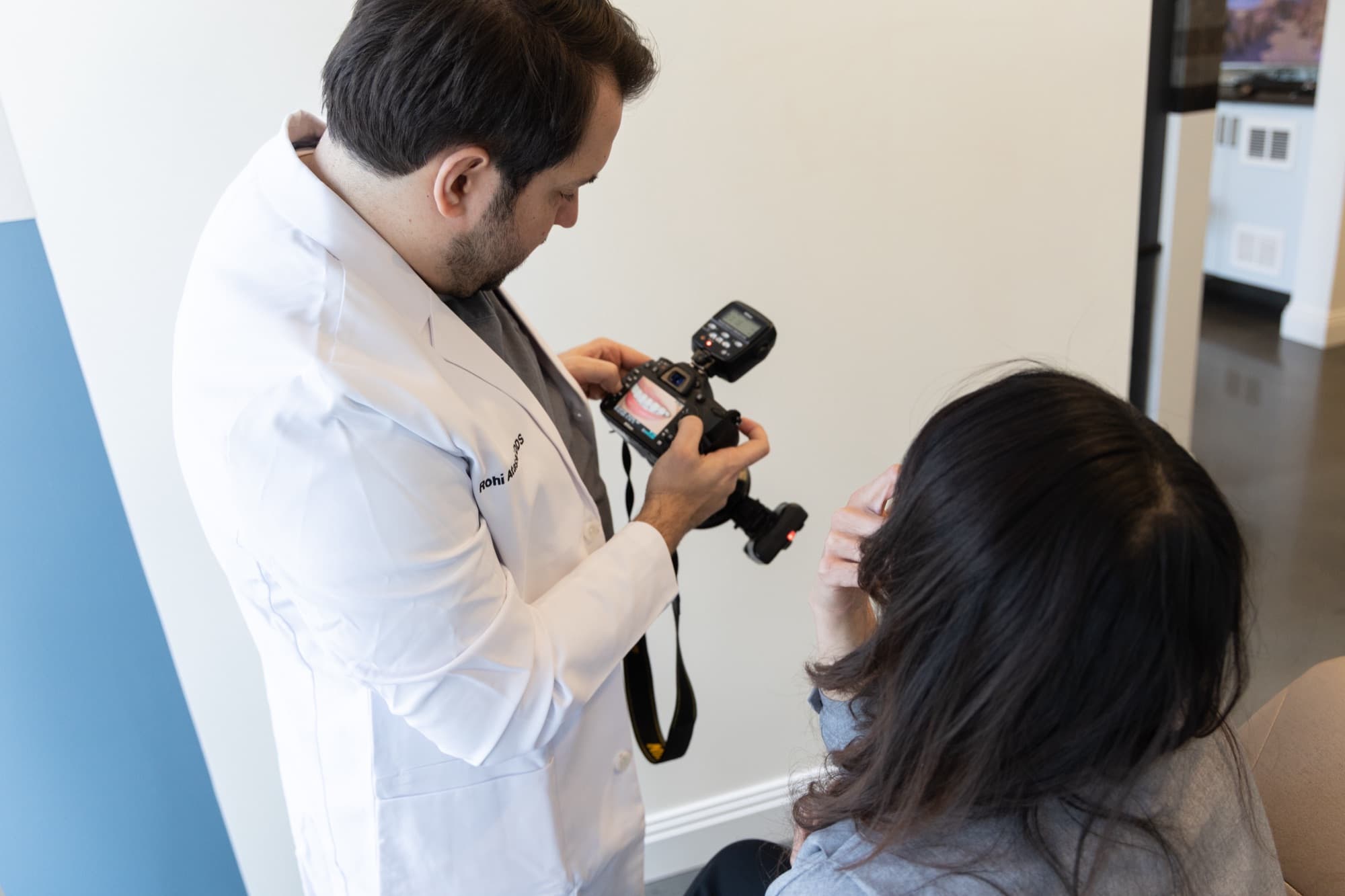 Dr. Atassi photographing a patient's smile