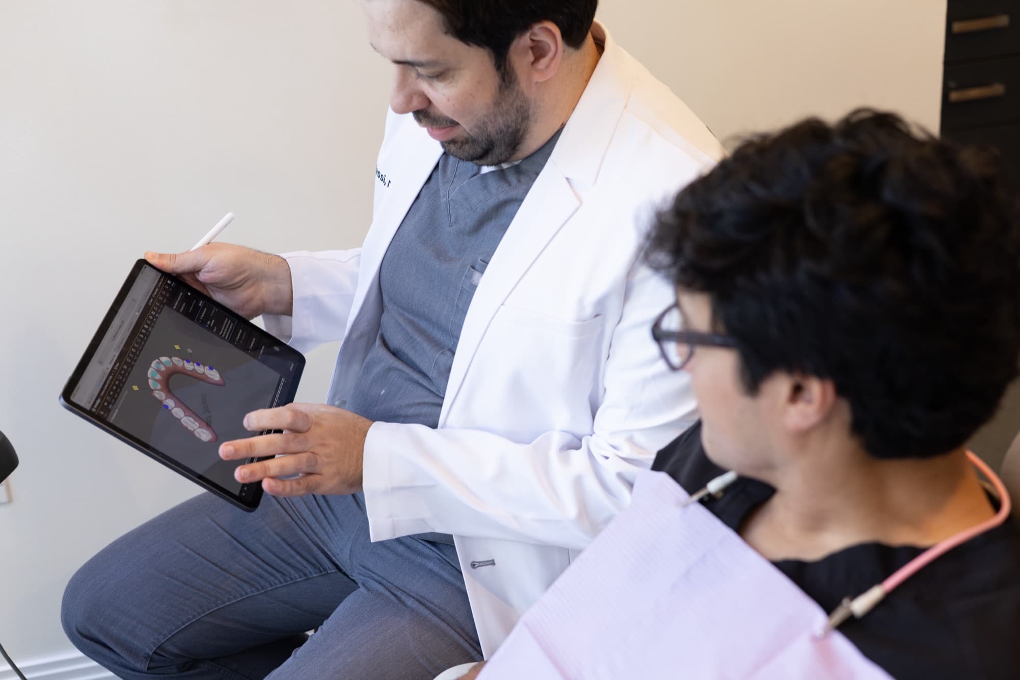 Dr. Atassi walking a patient through the plan on an iPad