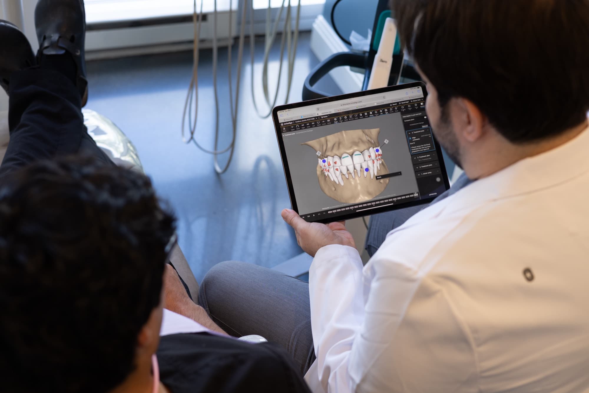 Dr. Atassi reviewing a case on a tablet